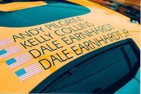 Picture of Dale leaning over and kissing the hood of his car.