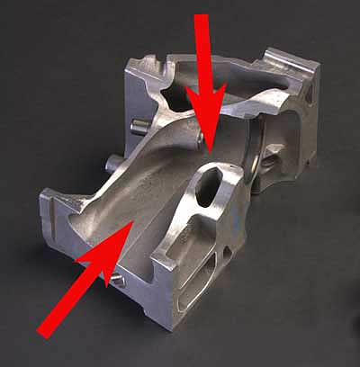 This vertical saw-cut of an LS2 head's intake port shows two reasons why it flows so well, 1) cross-sectional area is maintained with the port growing wider at the points where it grows shorter and 2) the smoothly-curved, short side radius-the area where the port floor curves down to the intake valve seat.<br />Image:  GM Communications