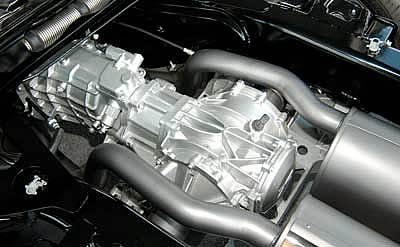 The 2005 Corvette exhaust system is quite different behind the transaxle. Transverse mufflers and a number of right-angle bends have been replaced with these longitudinal mufflers.<br />Image:  Sharkcom