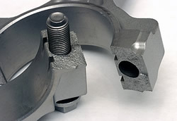 Rods with cracked or 'fracture-split' big ends are common on modern engines. The fracturing creates a unique interface that 'locks' together only one way and does so very precisely. The more accurate interface ensures a uniform big end diameter and shape.<br />Image:  Author