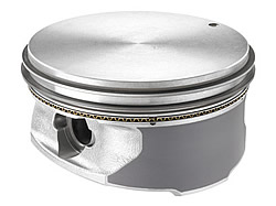 In the early LS1 years, because of the short-skirted piston necessary in the Gen 3/4 engine family, cold piston knock was a customer pleasability issue. Since the '02 LS6, Corvette pistons have had a polymer coating on their major and minor thrust surfaces-the gray area on this LS3 piston skirt. At the end of the break-in period, a lot of the polymer and a slight amount of piston material is worn away, leaving a very consistent skirt surface, a nominal (and tight) piston-to-bore clearance and hopefully, no cold piston knock.<br />Image:  Steve Constable/GMPT Communications.