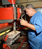 Mark DeGroff at the controls of his shop's Serdi Model 60. The first of the <em>CAC</em>'s replacement LS7 heads is having an intake valve seat 'touched up.'
