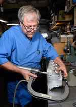 Mark DeGroff uses a Goodson pneumatic valve spring compressor (PN CF2004) to reassemble our now-repaired, new heads.