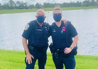 Officers Corona and Drug rescue a man from a lake in Port St. Lucie. (Port St. Lucie Police)
